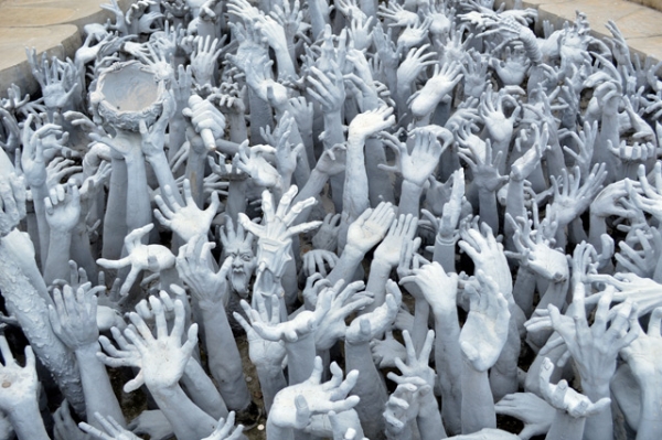 Grasping hands symbolize desire at the Wat Rong Khun Temple, also known as the White Temple, in Chiang Rai, Thailand on July 7, 2013. Construction is due to be completed in 2070. (Melissa Scott/Flickr)