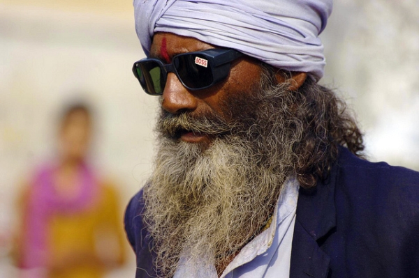 A bearded man with a  turban and dark glasses in Orchha, India on August 3, 2013. (Andrea Kirby/Flickr)
