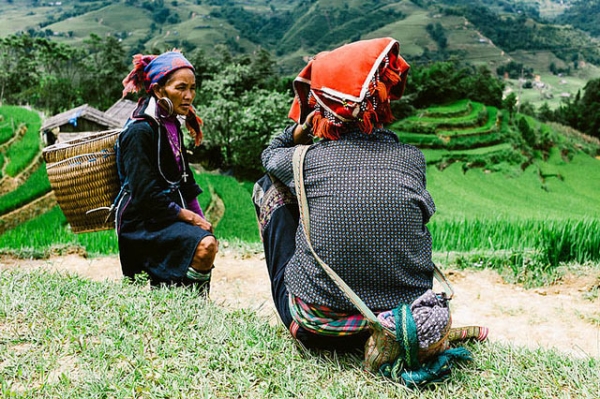 Two colorfully dressed women take in the view of Lao Chai Province, Vietnam on August 31, 2013. (Mattia Boero/Flickr)