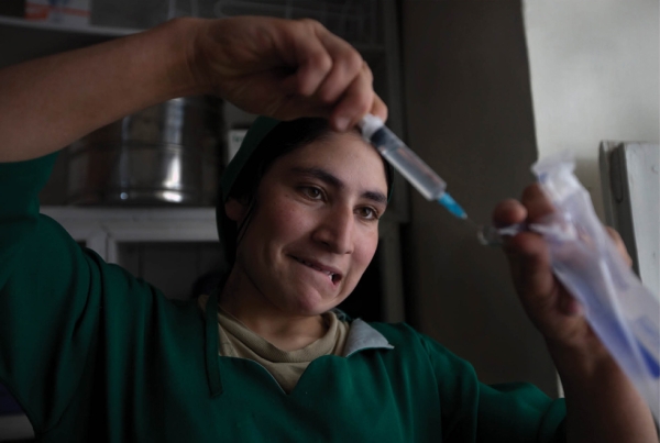 Bamiyan, 2009: Momina, a midwife student, prepares a needle with a painkiller to help a pregnant woman in labor in the delivery room at the Bamiyan Provincial hospital. (Paula Bronstein/Getty Images)