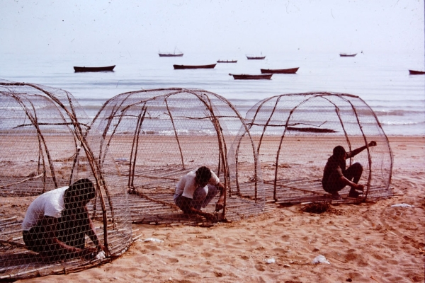 Caviar fishermen on the shores of the Caspian Sea mending their nets.