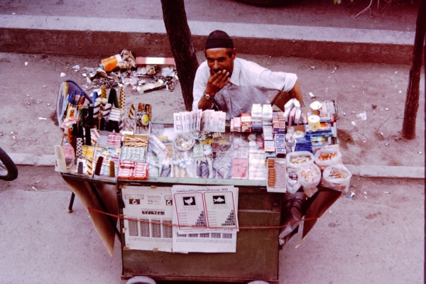 A street vendor sells cigarettes, gum, candy and lottery tickets. Found on many city streets.