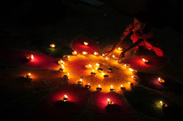 A Pakistani Hindu woman lights an earthen oil lamp in honor of Diwali in Karachi on October 26, 2011. (Rizwan Tabassum/AFP/Getty Images)