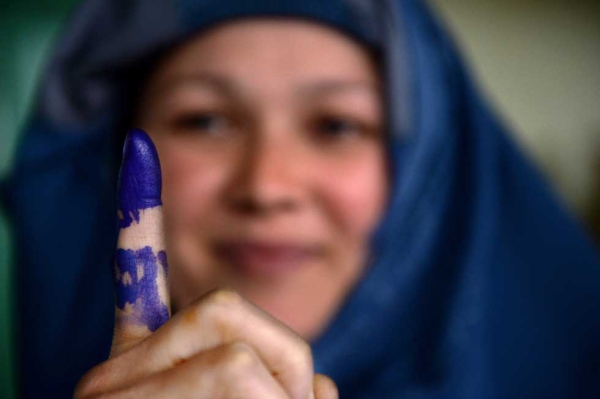 A voter shows her inked finger after she cast her ballot at a local polling station in Kabul on April 5, 2014. (Shah Marai/AFP/Getty Images) 