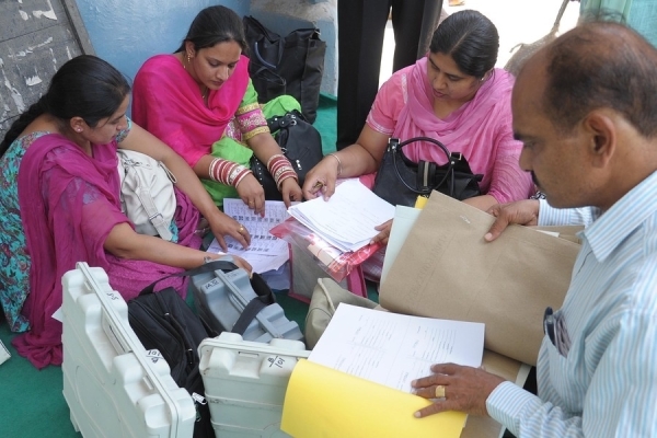 Indian polling staff match their individual electoral lists after collecting electronic voting machines and other election material at a distribution centre in Amritsar on April 29, 2014 on the eve of Lok Sabha - lower house - elections. (Nariner Nanu/AFP/Getty Images)