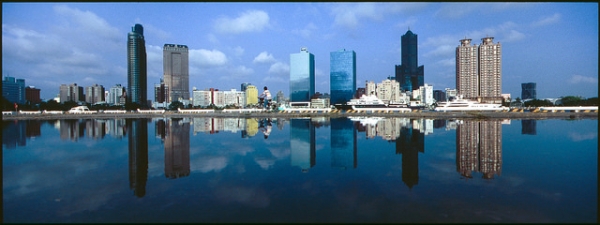 Buildings and people are reflected upside down in the water at Kaohsiung Love Pier in Kaohsiung City, Taiwan on April 15, 2014. 