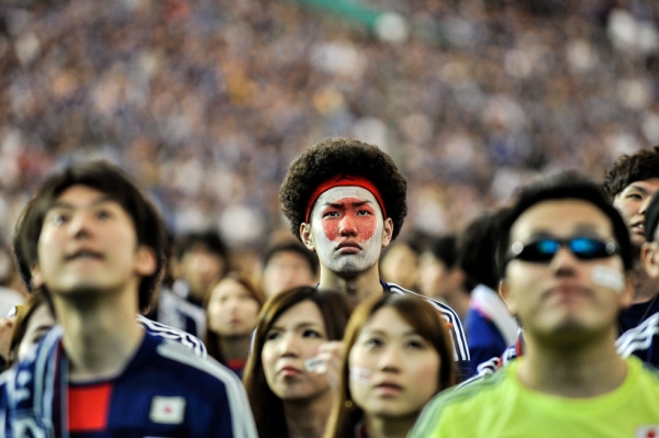 Japanese fans react after Japan is defeated during the 2014 World Cup match between Japan and Cote d'Ivoire during the public viewing event at Tokyo Dome on June 15, 2014. (Keith Tsuji/Getty Images)