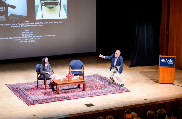 Nam June Paik authority John G. Hanhardt (R) imitates Paik's Robot K-456 in his talk with exhibition curator Michelle Yun (L) on Sept. 9, 2014. (C. Bay Milin/Asia Society)