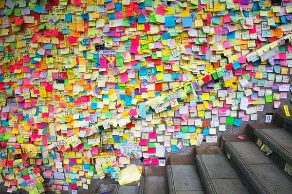 Hundreds of post-it notes carrying messages from protestors line a public wall in Hong Kong on October 28, 2014. (Victor Wong/Flickr)