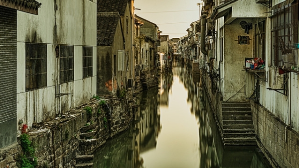 A small, nostalgic town resides along a mirror-like river in Suzhou, China on February 19, 2015. (Vlad Meytin/Flickr)