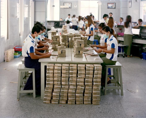 KBZ bank employees count kyat currency notes at one of the branches in Yangon. (Andrew Rowat)
