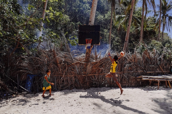 A young boy jumps up to dunk a basketball in Borocay, Philippines on March 15, 2015. (ilya/Flickr)
