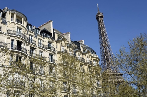 A Haussmannian-style building next to the Eiffel tower in Paris. (Bertrand Guay/Getty Images)