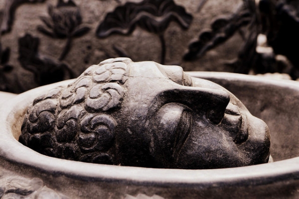 A Buddha head is seen carved into a stone bowl at Panjiayuan Flea Market in Beijing, China on May 16, 2015. (Gwendolyn Stansbury/Flickr)