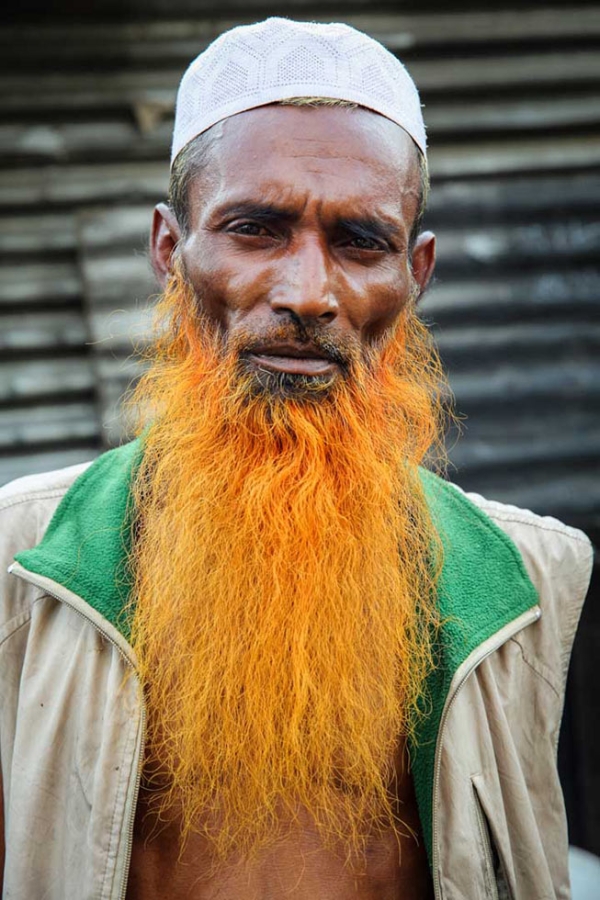 An old man with a light orange henna-dyed beard. (GMB Akash)