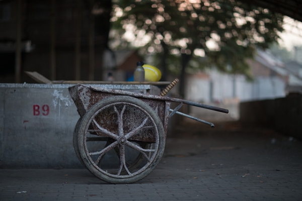 A rusty wheelbarrow is parked on a deserted street in Beijing, China on September 16, 2015. (Jens Schott Knudsen/Flickr)