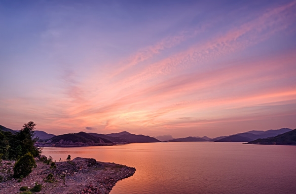 High Island Reservoir in Hong Kong is lit up in a purple glow under the setting sun on September 6, 2015. (johnlsl/Flickr)