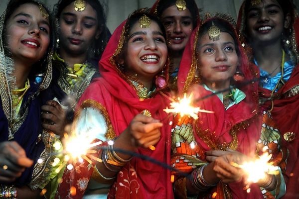 Indian schoolgirls share a light moment as they play with sparklers at a function in Amritsar on October 16, 2009, on the eve of the Diwali festival. (Narinder Nanu/AFP/Getty Images)