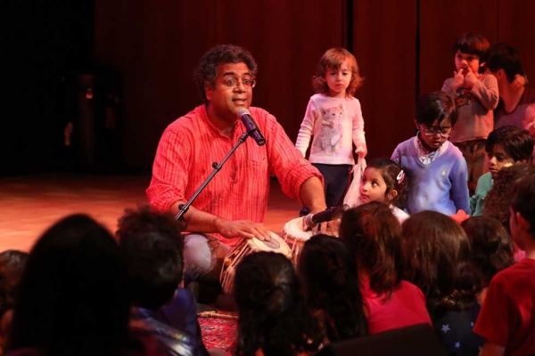 An instructor from Raga Kids introduces Indian classical music to young children. (Ellen Wallop/Asia Society)