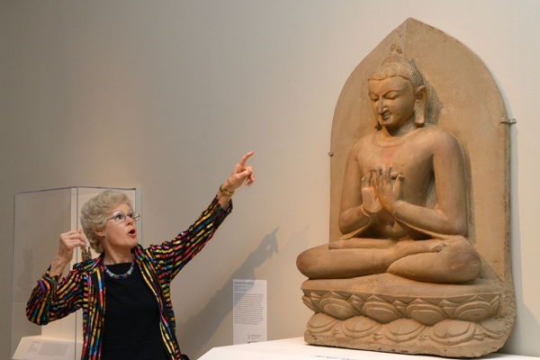 Guest co-curator Sylvia Fraser-Lu shows an artifact on display at the members opening for the Buddhist Art of Myanmar exhibit at Asia Society in New York on February 10, 2015. (Elsa Ruiz/Asia Society)