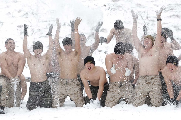 U.S. Marines from 3rd Marine Expeditionary force deployed from Okinawa, Japan, cover themselves in snow with South Korean marines during a winter military exercise on January 28, 2016 in Pyeongchang, South Korea. (Chung Sung-Jun/Getty)