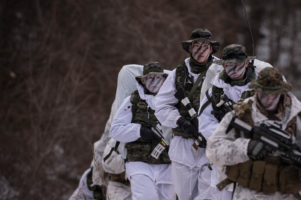 South Korean and U.S. soldiers walk in the snow during a joint annual winter exercise in Pyeongchang, South Korea on January 28, 2016. (Ed Jones/AFP/Getty)