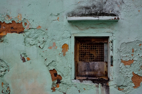 A rusty window set in a peeling wall in Macau on January 4, 2016. (roaming-the-planet/Flickr)