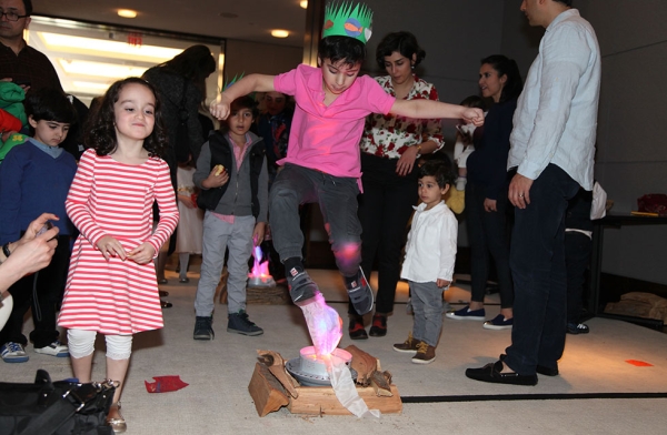 Children participate in a version of Chaharshanbeh Suri (fire jumping) to celebrate Nowruz at Asia Society New York on March 12, 2016. (Ellen Wallop/Asia Society)