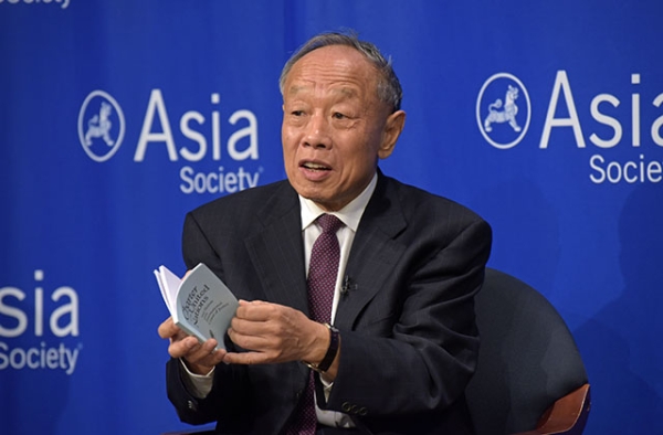 Former Chinese Foreign Minister Li Zhaoxing holds a copy of the Charter of the United Nations at Asia Society in New York. (Elsa Ruiz/Asia Society)