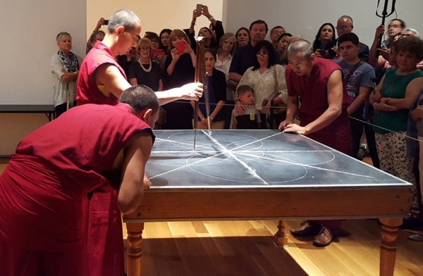 Monks from the Drepung Loseling Monastery begin the construction of a sand mandala in Houston, Texas on August 21, 2015. (Tiffany Chen/Asia Society)