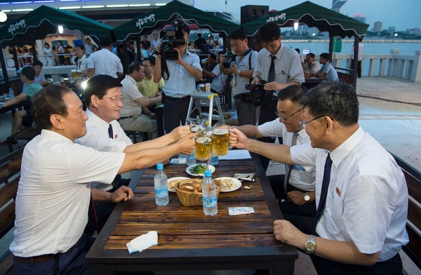 Choe Yong Nam (L), director of the General Bureau of Public Service who doubles as chairman of the preparatory committee for the festival, says 'cheers' with other officials after the opening ceremony of the Pyongyang Taedonggang Beer Festival on August 12, 2016. (Kim Won-jin/AFP/Getty Images)