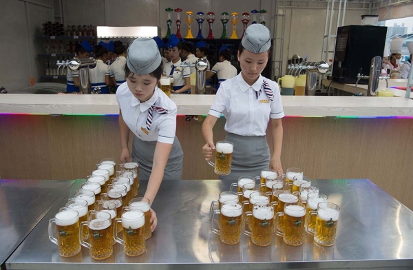 Waitresses prepare jugs of beer before the opening of the Pyongyang Taedonggang Beer Festival. (Kim Won-jin/AFP/Getty Images)