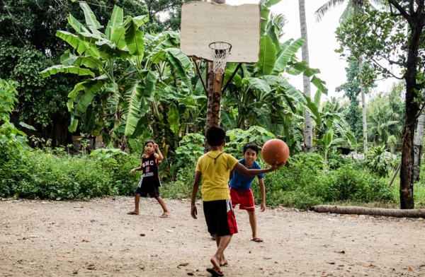 In the local villages, most children and adults play in just flip-flops. Cebu, Philippines. (Richard James Daniels)