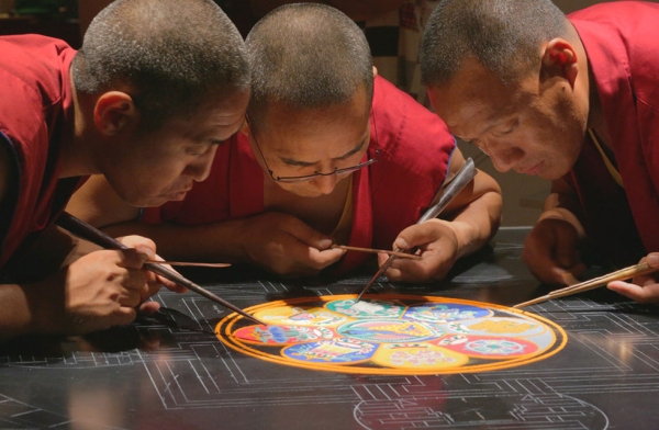 Monks use a funnel-like tool called chak-pur to create the sand mandala with precision in Houston, Texas on August 21, 2015. (Joel Luks/Asia Society)