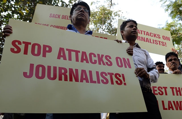 On February 17, 2016, Indian journalists shout slogans during a protest to condemn an assault on fellow media workers by lawyers at a court in New Delhi. (Indranil Mukherjee/AFP/Getty Images)