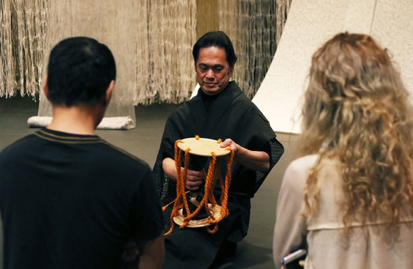 Japanese Noh drummer Shonosuke Okura leads a workshop on the drum he used during his performance of 'Recycling: Washi Tales' in New York on March 26, 2016. (Asia Society/Ellen Wallop)