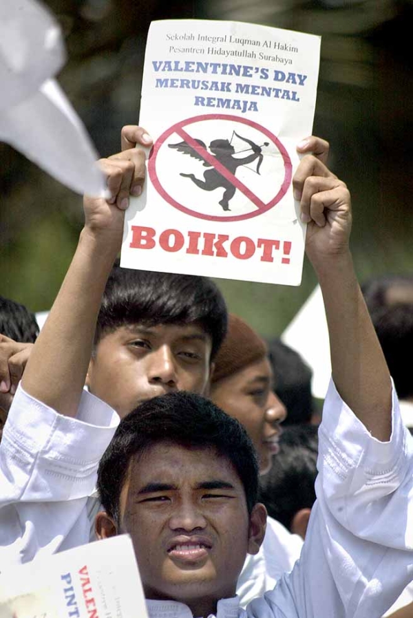 Indonesian male students from a local Islamic boarding school hold anti-Valentine's Day placards during a protest in Surabaya, East Java province on February 13, 2012. (Juni Kriswanto/AFP/Getty)
