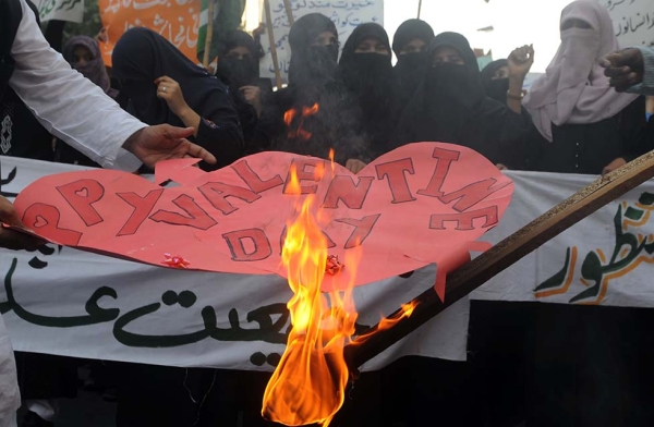 Pakistani women belonging to religious party Jamiat-e-Ulama Pakistan set fire to Valentine's Day cards during a protest against the holiday in Karachi on February 14, 2012. (Rizwan Tabassum/AFP/Getty)