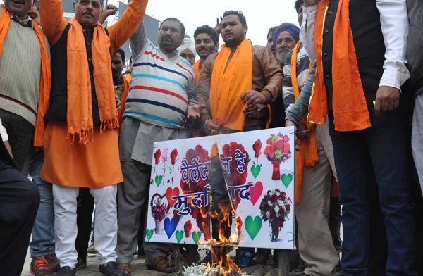 Indian activists from the right wing Hindu nationalist group Shiv Sena set fire to a placard during a demonstration denouncing Valentine's Day in Amritsar on February 11, 2016. Since economic liberalization, the holiday has become somewhat popular among middle-class Indians, but right wing groups like Shiv Sena oppose Valentine's Day celebrations, citing them as a cultural invasion on the Hindu way of life. (Arinder Nanu/AFP/Getty)