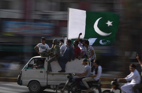 Pakistani residents carry a national flag as they drive around to mark the country's Independence Day in Karachi on August 14, 2017. (Asif Hassan/AFP/Getty)