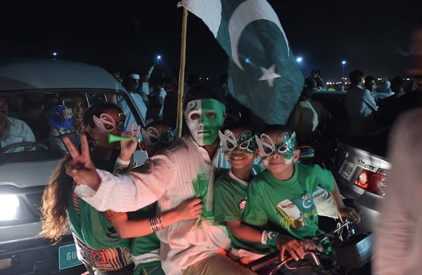 Youths wear masks as they march on a street in Islamabad on August 13, 2017, to mark the country's Independence Day. (Aamir Qureshi/AFP/Getty)