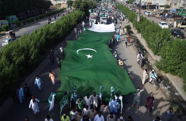 Pakistani residents carry a huge flag during a rally to mark the country's Independence Day in Karachi on August 14, 2017. (Asif Hassan/AFP/Getty) 