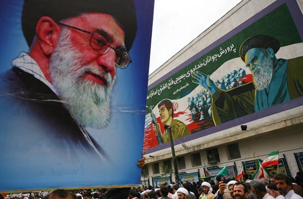 A pro-government demonstrator holds aloft a picture of Ayatollah Ali Khamenei at Tehran University. (Getty)