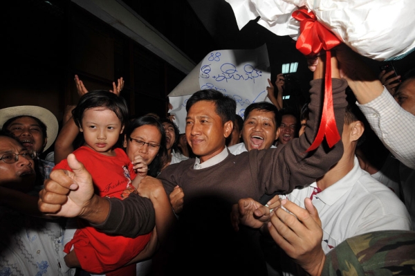 Myanmar political prisoner Kyaw Min Yu (C), known as Jimmy, and his wife Ni Lar Thein (L) holding her child, both members of the 88 Generation student group, celebrate upon their arrival at Yangon international airport following their release from detention on January 13, 2012. Myanmar pardoned prominent dissidents, journalists and a former premier on January 13 under a major prisoner amnesty, intensifying a surprising series of reforms by the army-backed regime. (Soe Than Win/AFP/Getty Images)