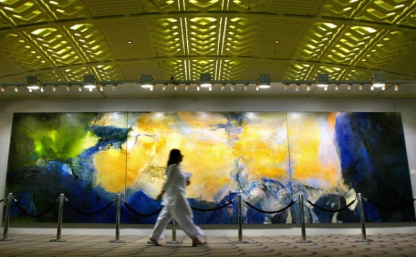 A woman walks past the world's largest triptych ever, produced by painter Zao Wou-ki and displayed at the Christie's Hong Kong Spring Auction preview in Hong Kong on May 26, 2005. (Philippe Lopez/AFP/Getty Images) 