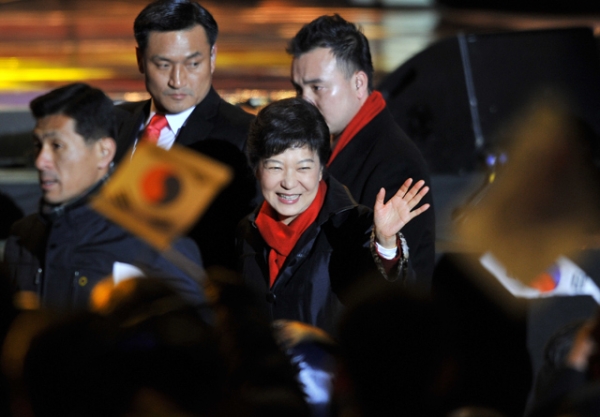 South Korea's president-elect Park Geun-Hye waves to supporters as she arrives to deliver a victory speech on a stage in the centre of Seoul on December 19, 2012. (Jung Yeon-Je/AFP/Getty Images)