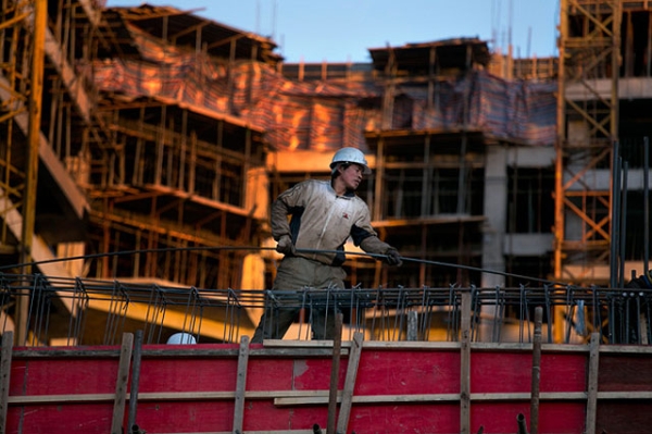 A Chinese construction worker sets rebar on an apartment building under construction as a development and a real estate boom takes hold in Ulaanbaatar, Mongolia, in October 2012. (Paula Bronstein/Getty Images)