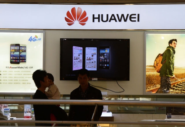 Shoppers walk past a Huawei store in Beijing on March 24, 2014. Chinese telecoms and Internet giant Huawei condemned the U.S. National Security Agency on March 24 after reports revealed the organization had been secretly tapping the company's networks for years. (Mark Ralston/AFP/Getty Images) 