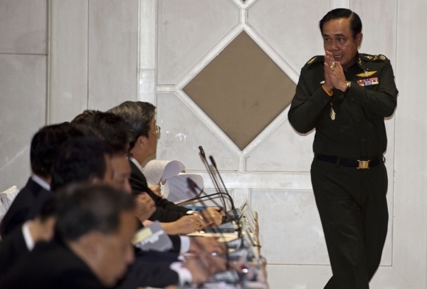 Thai army chief General Prayut Chan-O-Cha gives a traditional greeting to delegates during a meeting at the Army Club in Bangkok on May 20, 2014. Thailand's army declared martial law after months of deadly anti-government protests, deploying armed troops in central Bangkok and censoring the media but insisting the move was 'not a coup'. (Pornchai Kittiwongsakul/AFP/Getty Images)