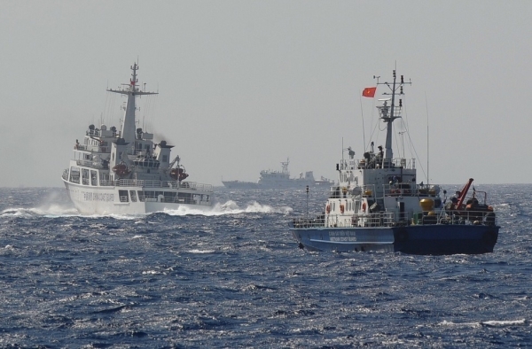 This picture taken on May 14, 2014 shows a Chinese coast guard vessel (L) followed by a Vietnamese coast guard ship (R) near the area of China's oil drilling rig in disputed waters in the South China Sea. (Hoang Dinh Nam/AFP/Getty Images)